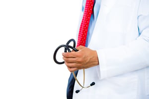 A close-up cropped portrait of a male doctor holding a stethoscope bringing bad news patient, isolated on white background